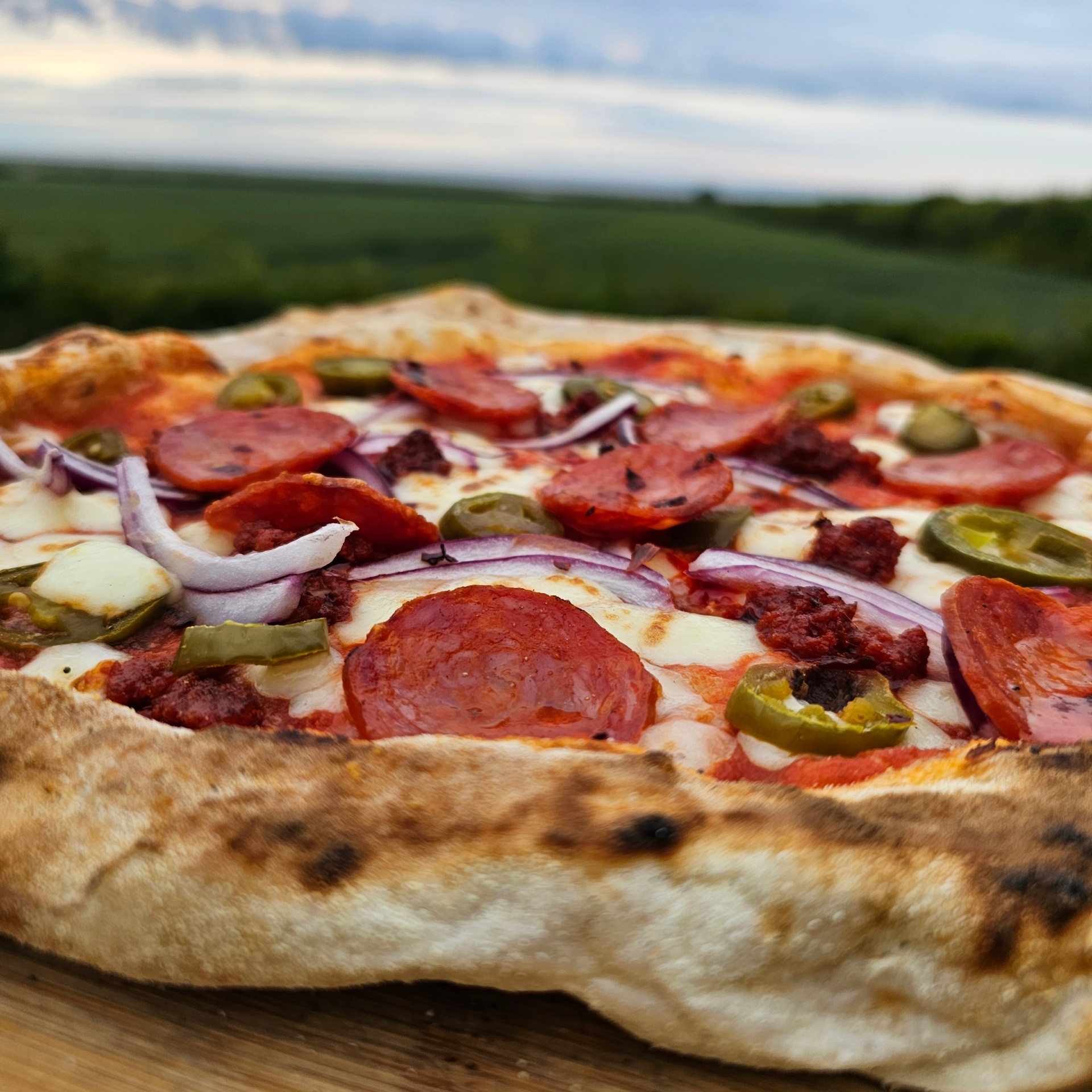 Wood-fired pepperoni pizza with the Norfolk countryside beyond