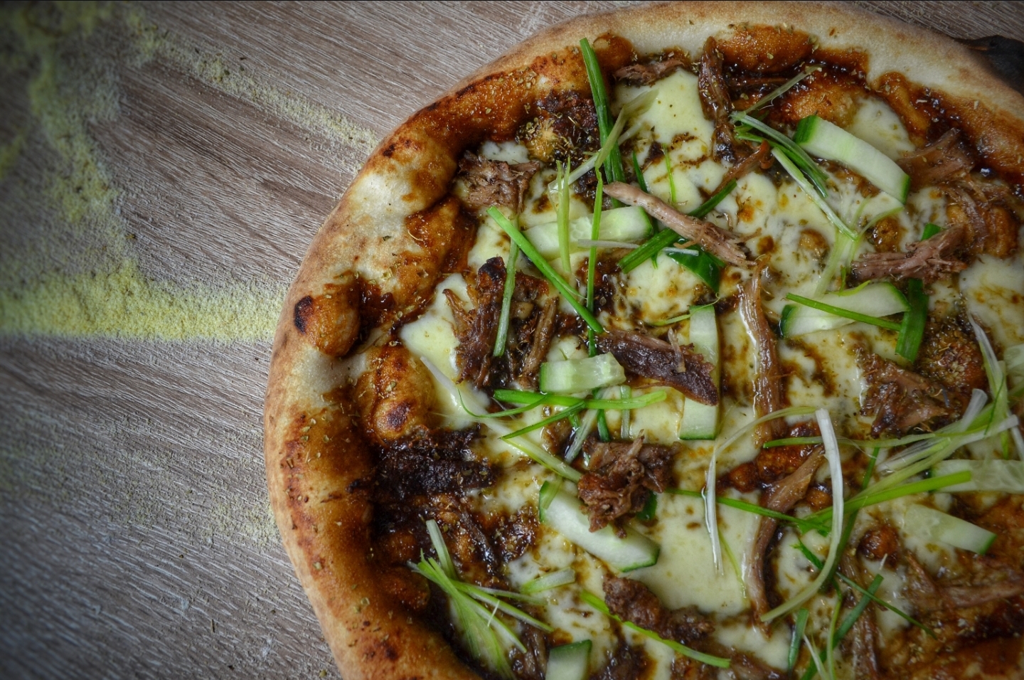 Pulled duck and hoisin pizza with cucumber and spring onion — a signature special